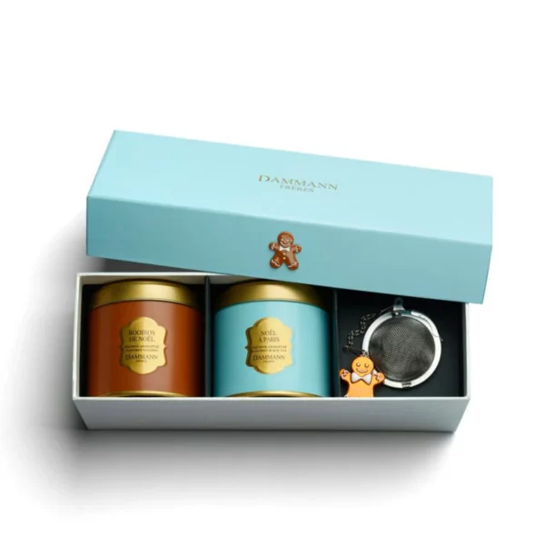 Coffret Noël Givré Dammann Frères – coffret bleu polaire avec deux boîtes métal de 40 g ("Noël à Paris" & rooibos de Noël) et un infuseur décoratif.